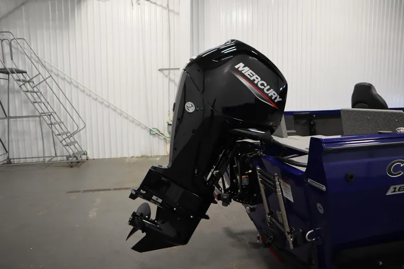 Slide: The Image of 2026 Crestliner 1650 Hawk Side Console with Mercury outboard motor in a garage setting. - 44