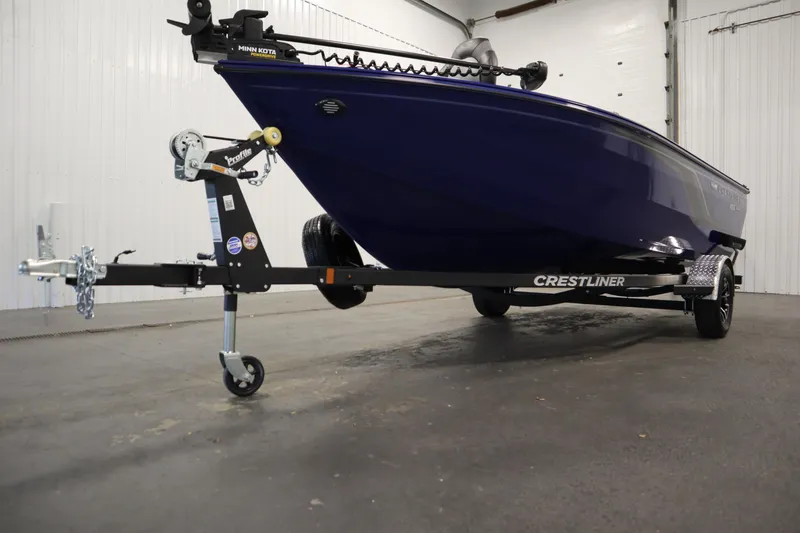 Slide: The Image of 2026 Crestliner 1650 Hawk Side Console boat on trailer in indoor setting. - 49