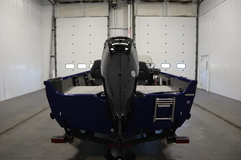 Slide: The Image of 2026 Crestliner 1650 Hawk Side Console boat in a garage, rear view. - 5