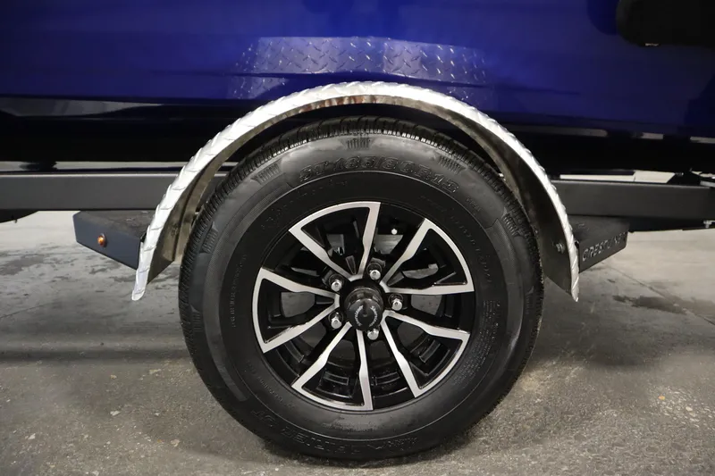 Slide: The Image of 2026 Crestliner 1650 Hawk Side Console trailer wheel with black alloy rim. - 50