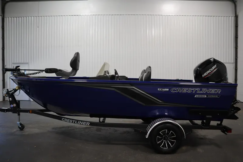 Slide: The Image of 2026 Crestliner 1650 Hawk Side Console boat with Mercury engine on trailer. - 7