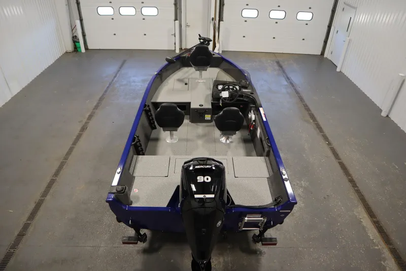 Slide: The Image of 2026 Crestliner 1650 Hawk Side Console boat in a garage, featuring a Mercury 90 engine. - 9