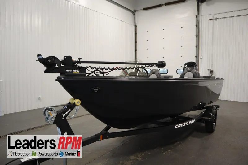 The Image of 2026 Crestliner 1750 Hawk Side Console boat in showroom, featuring Minn Kota trolling motor. - 0
