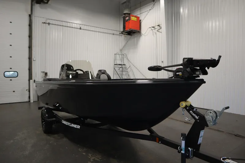 Slide: The Image of 2026 Crestliner 1750 Hawk Side Console boat in a garage setting. - 2