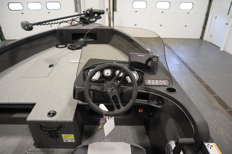Slide: The Image of 2026 Crestliner 1750 Hawk Side Console boat interior with steering wheel and control panel. - 20