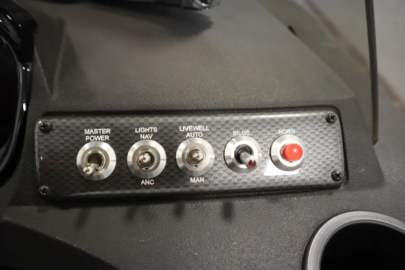 Slide: The Image of Control panel of 2026 Crestliner 1750 Hawk Side Console with switches for power, lights, and horn. - 26