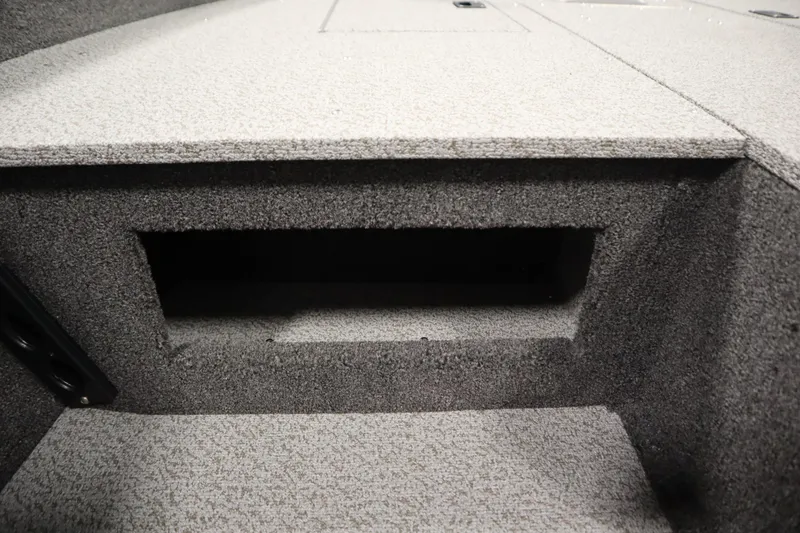 Slide: The Image of Crestliner 1750 Hawk Side Console 2026, interior storage compartment, carpeted finish. - 31