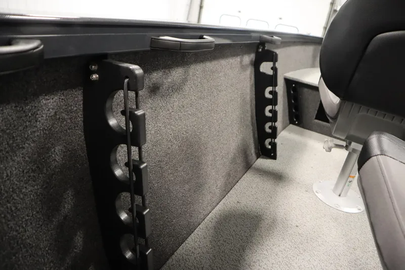 Slide: The Image of 2026 Crestliner 1750 Hawk Side Console interior with rod holders and seating. - 32