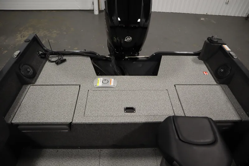 Slide: The Image of 2026 Crestliner 1750 Hawk Side Console boat interior with storage compartments and motor. - 36