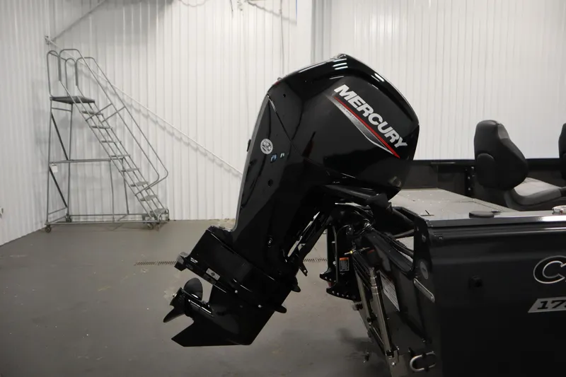 Slide: The Image of 2026 Crestliner 1750 Hawk Side Console with Mercury outboard motor in a garage setting. - 39