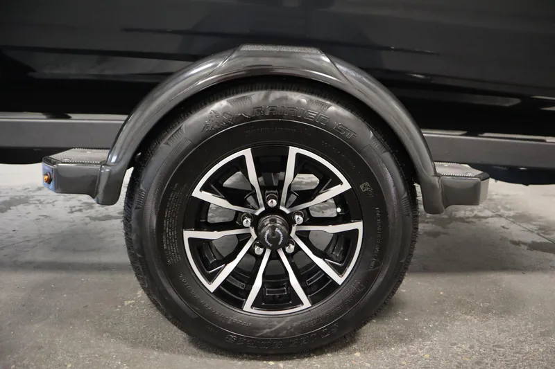 Slide: The Image of Trailer wheel of 2026 Crestliner 1750 Hawk Side Console boat, featuring black and silver design. - 43