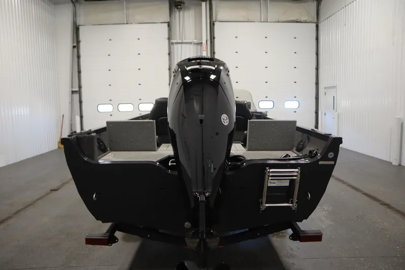 Slide: The Image of 2026 Crestliner 1750 Hawk Side Console boat in a garage, rear view. - 5