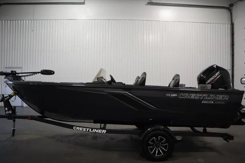 Slide: The Image of 2026 Crestliner 1750 Hawk Side Console boat in a showroom, side view. - 7