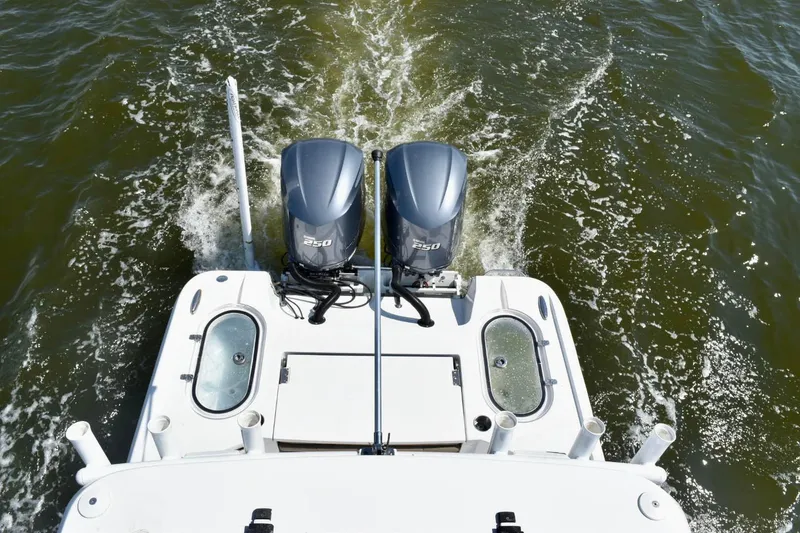 Slide: The Image of 2021 Blazer Bay 2700 Hybrid Bay boat with dual 250 engines on water. - 10