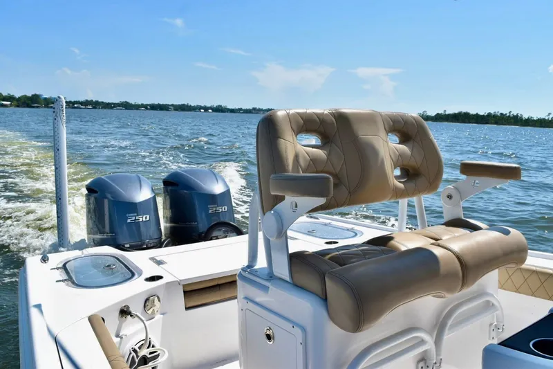 Slide: The Image of 2021 Blazer Bay 2700 Hybrid Bay boat with dual 250 engines on open water. - 11