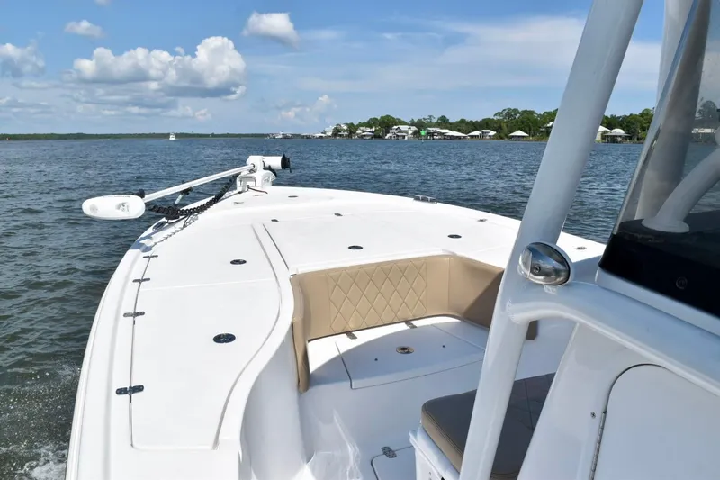 Slide: The Image of 2021 Blazer Bay 2700 Hybrid Bay boat on calm water, clear sky background. - 9
