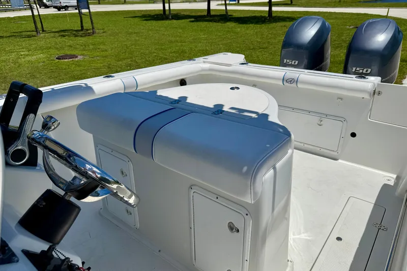Slide: The Image of 2003 Sailfish 266 CC boat interior with dual 150 engines, steering wheel, and seating. - 12