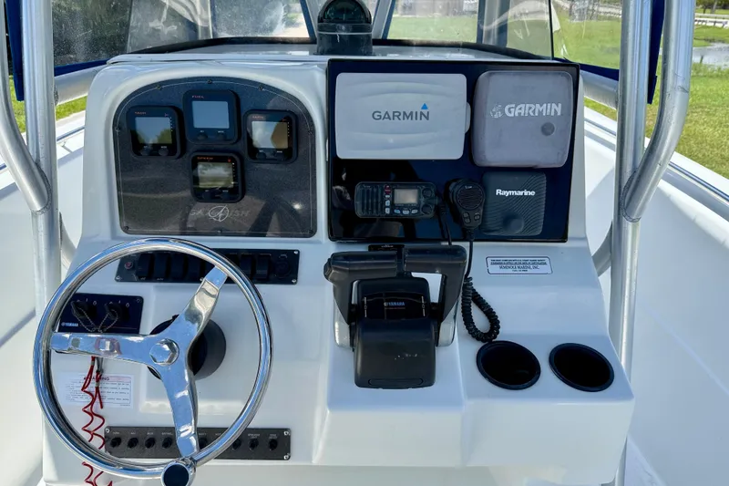 Slide: The Image of Center console of 2003 Sailfish 266 CC boat with Garmin and Raymarine electronics. - 14
