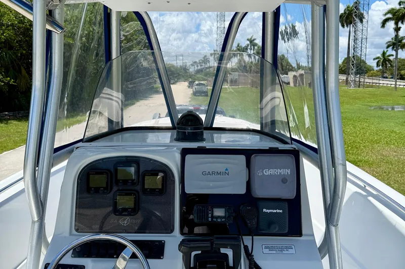 Slide: The Image of 2003 Sailfish 266 CC boat dashboard with Garmin navigation equipment and steering wheel. - 15