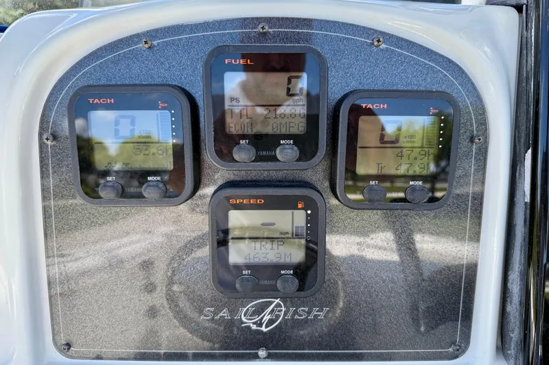 Slide: The Image of Dashboard of a 2003 Sailfish 266 CC boat with tachometer and fuel gauges. - 16