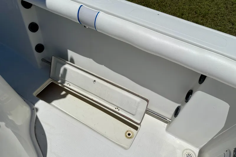 Slide: The Image of 2003 Sailfish 266 CC boat interior with storage compartment and rod holders. - 28