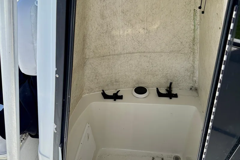 Slide: The Image of Interior view of a 2003 Sailfish 266 CC boat compartment with storage features. - 31