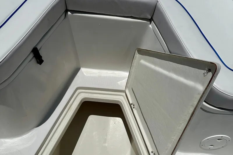 Slide: The Image of Open storage compartment on 2003 Sailfish 266 CC boat with cushioned seating. - 34