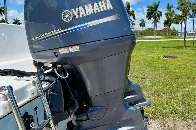Slide: The Image of Yamaha four-stroke engine on 2003 Sailfish 266 CC boat, grassy background. - 35