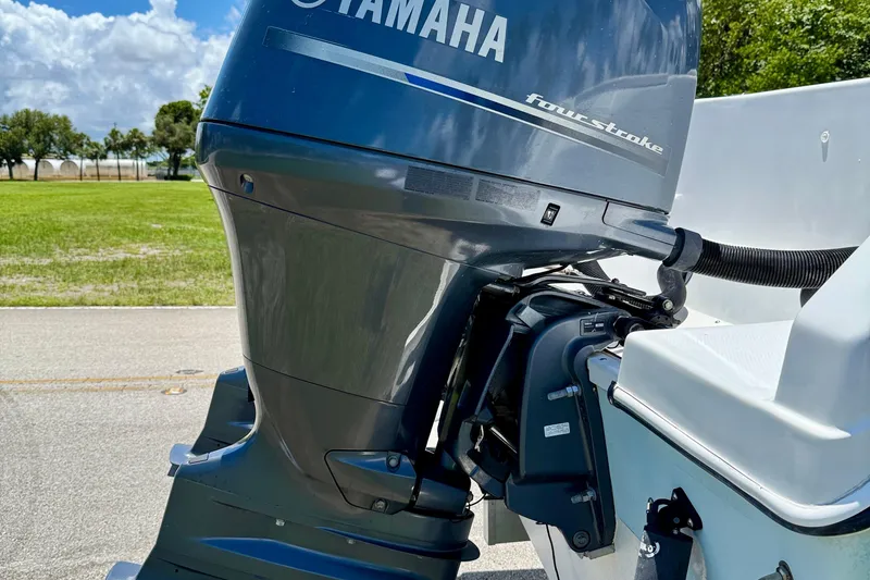 Slide: The Image of Yamaha four-stroke outboard motor on 2003 Sailfish 266 CC boat, sunny day background. - 36
