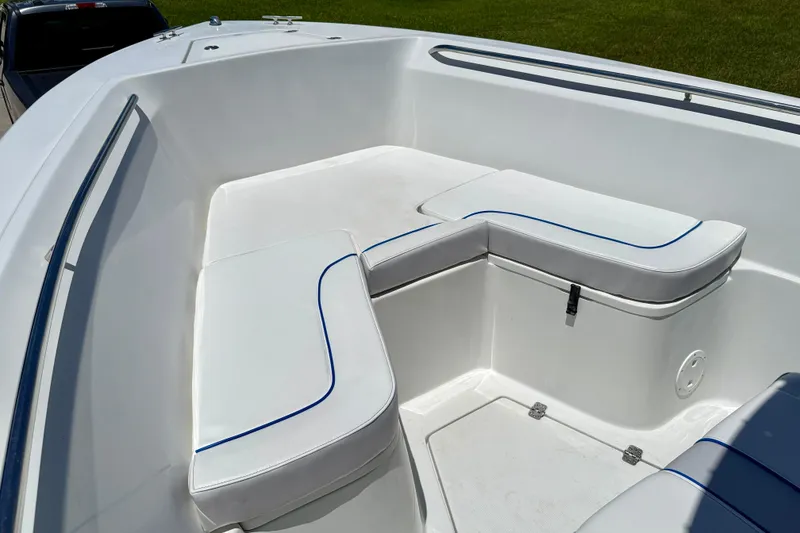 Slide: The Image of 2003 Sailfish 266 CC boat interior with white cushioned seating and blue trim. - 9
