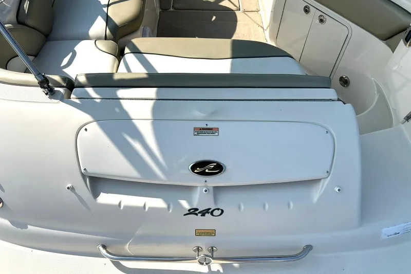 Slide: The Image of 2006 Sea Ray 240 Sundeck boat interior with seating and storage compartments. - 19