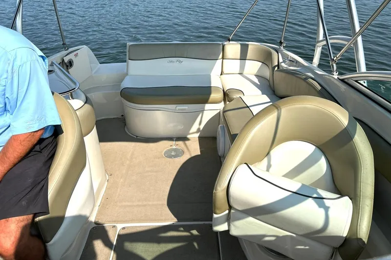 Slide: The Image of Interior of a 2006 Sea Ray 240 Sundeck boat with beige seating and water view. - 23