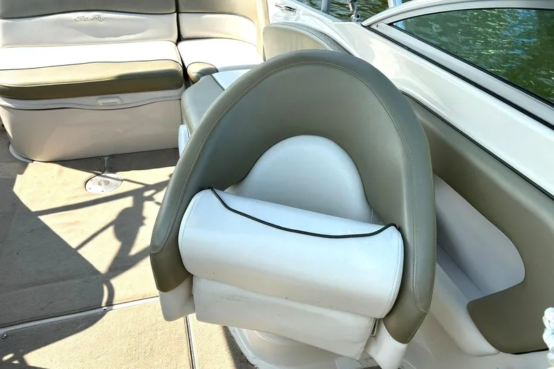Slide: The Image of 2006 Sea Ray 240 Sundeck interior with beige and white seating. - 24