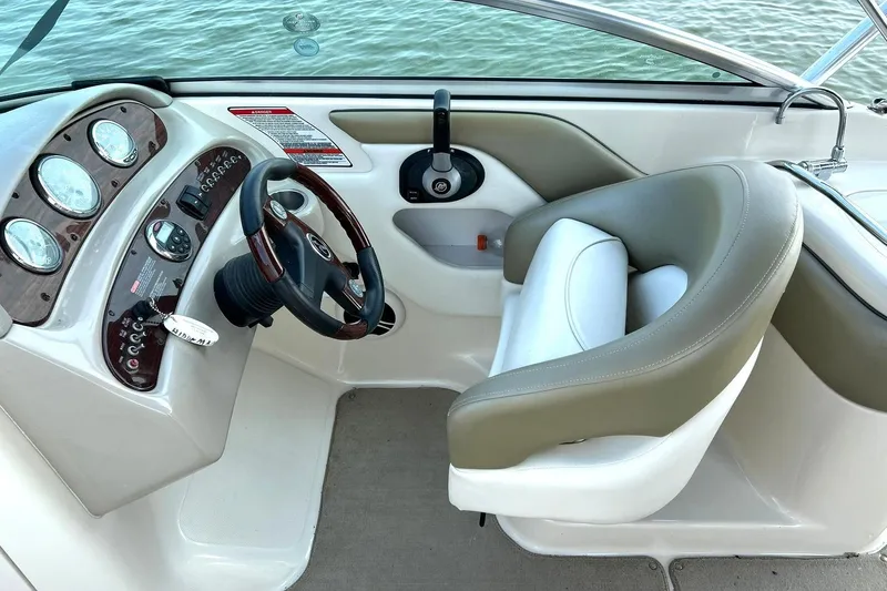 Slide: The Image of Interior view of 2006 Sea Ray 240 Sundeck boat cockpit with steering wheel and gauges. - 27