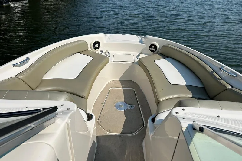 Slide: The Image of 2006 Sea Ray 240 Sundeck interior with spacious seating, overlooking calm water. - 31