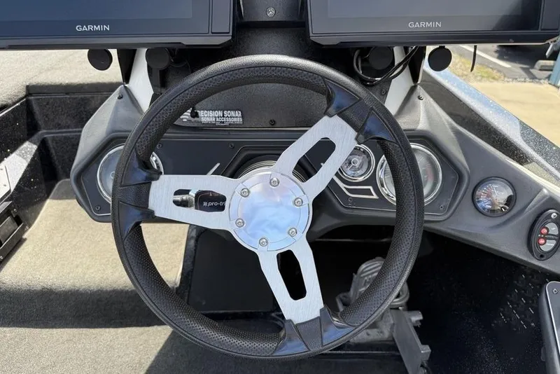 Slide: The Image of Steering wheel of a 2016 Skeeter ZX250 boat with Garmin displays and sonar accessories. - 12