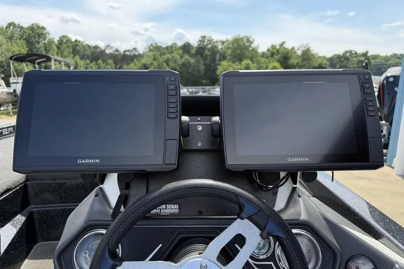 Slide: The Image of Dual Garmin displays on 2016 Skeeter ZX250 boat dashboard, surrounded by lush greenery. - 15