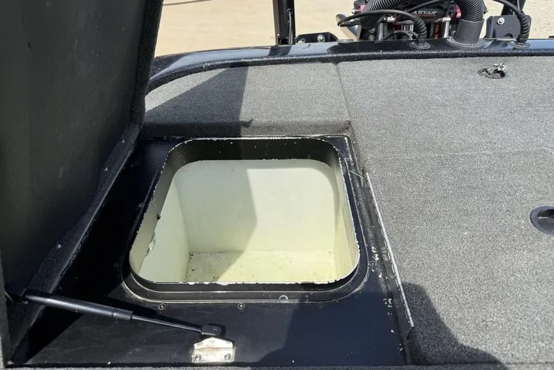 Slide: The Image of Open storage compartment on a 2016 Skeeter ZX250 boat deck. - 17