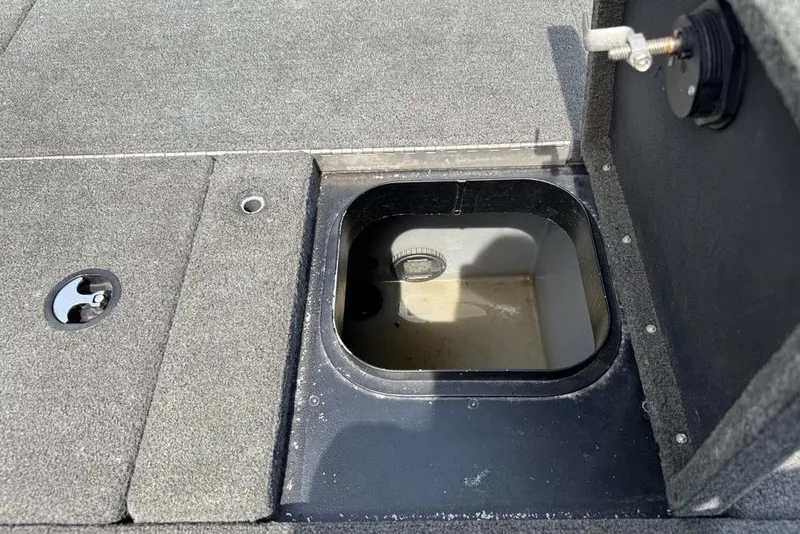 Slide: The Image of 2016 Skeeter ZX250 boat storage compartment with open hatch, showing interior details. - 18
