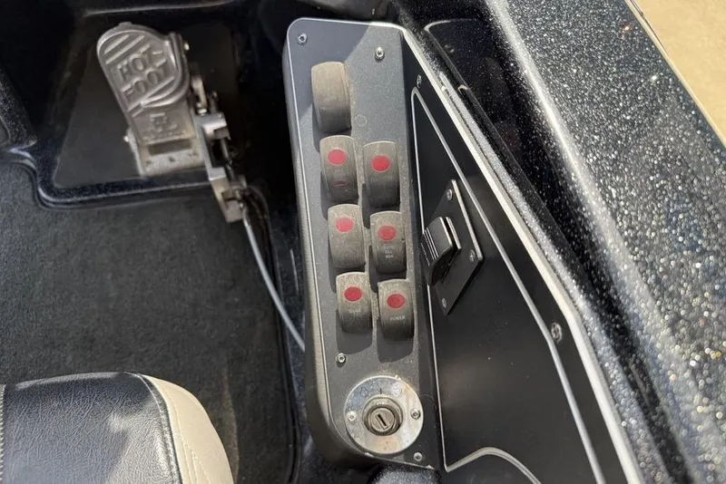 Slide: The Image of Control panel of a 2016 Skeeter ZX250 boat with switches and foot pedal. - 19