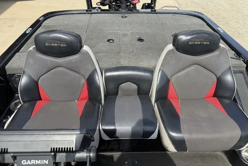 Slide: The Image of 2016 Skeeter ZX250 boat seats with red and gray design, featuring Garmin equipment. - 21