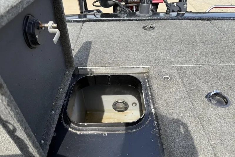 Slide: The Image of 2016 Skeeter ZX250 boat storage compartment with open hatch, showing interior details. - 23