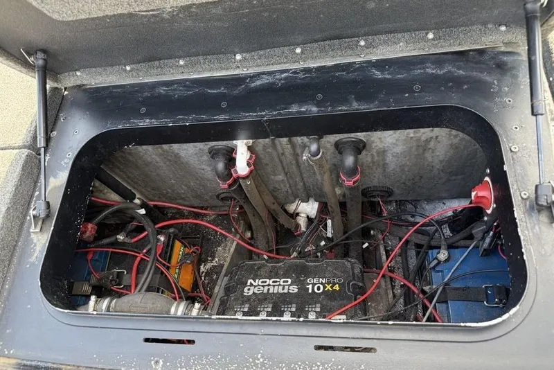 Slide: The Image of 2016 Skeeter ZX250 boat battery compartment with Noco Genius charger and wiring. - 24