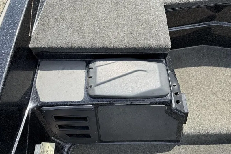 Slide: The Image of 2016 Skeeter ZX250 boat interior with storage compartments and cushioned seating. - 9