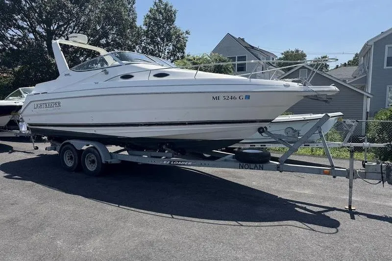 Slide: The Image of 2000 Weldcraft 26 Martinque boat on trailer, parked outdoors. - 1