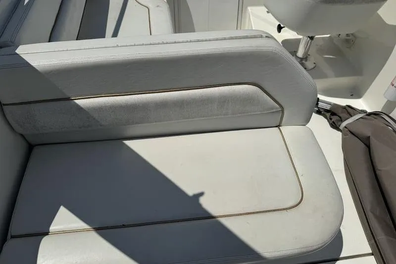 Slide: The Image of Weldcraft 26 Martinque 2000 boat interior seating with white upholstery. - 11