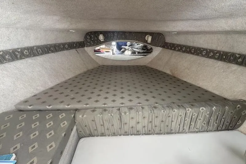 Slide: The Image of Cozy cabin interior of 2000 Weldcraft 26 Martinque boat with patterned upholstery. - 13