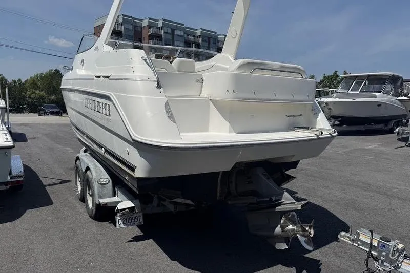 Slide: The Image of 2000 Weldcraft 26 Martinque boat on trailer in parking lot, rear view. - 14