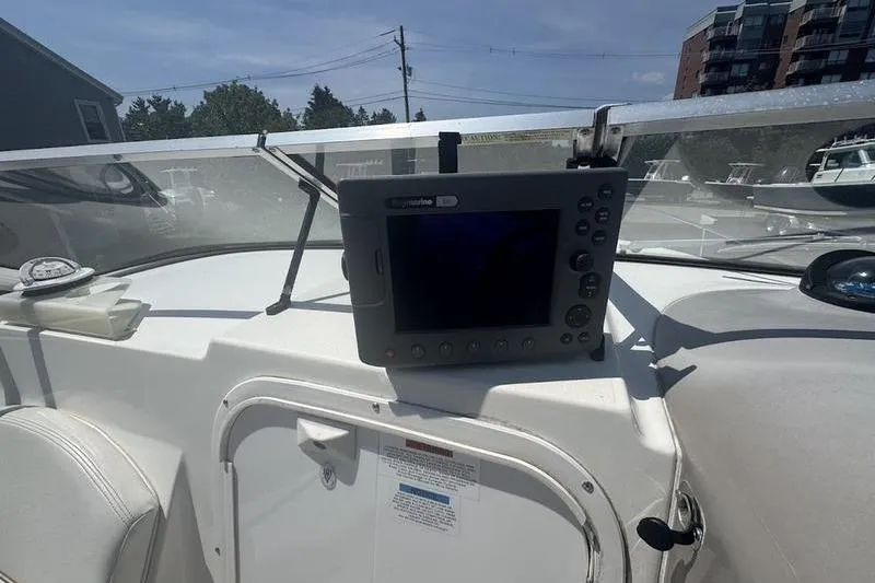 Slide: The Image of 2000 Weldcraft 26 Martinque boat dashboard with navigation equipment and compass. - 15