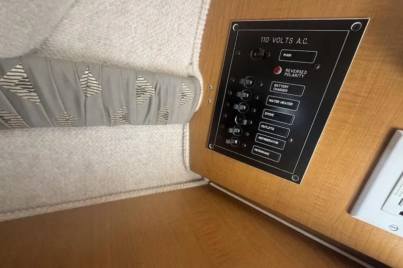 Slide: The Image of Electrical panel inside 2000 Weldcraft 26 Martinque boat, featuring various switches and controls. - 18